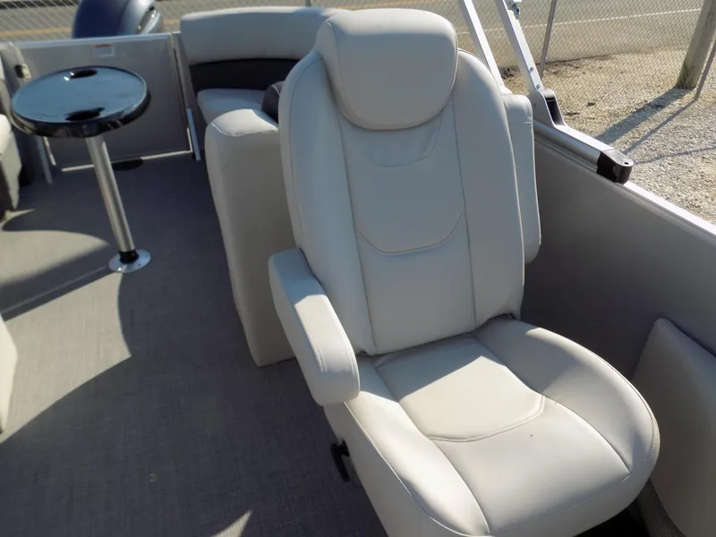 Slide: The Image of 2023 Sylvan Mirage 8522 LZ boat interior with plush seating and table. - 9
