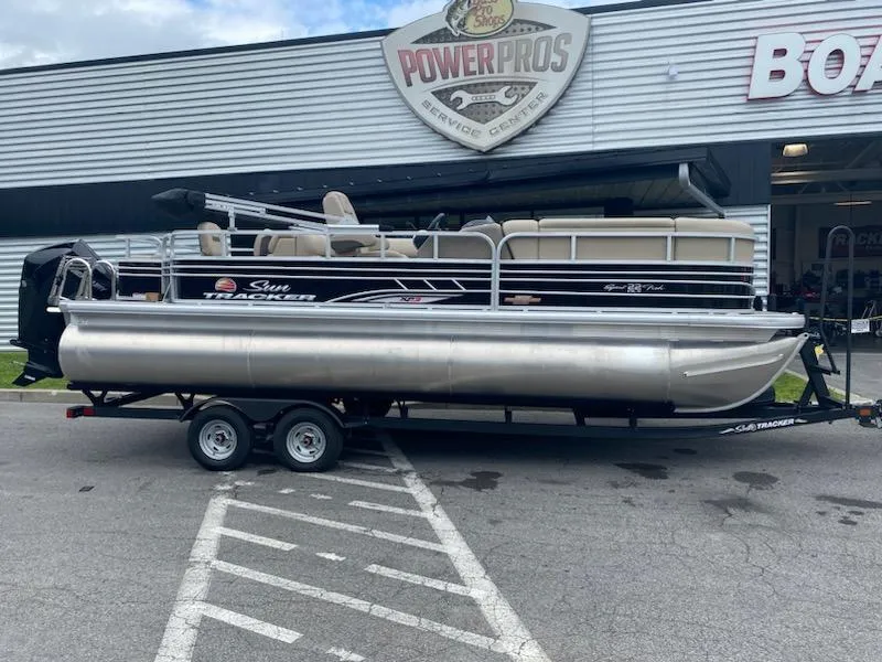 The Image of 2023 Sun Tracker SportFish 22 XP3 pontoon boat on trailer outside Power Pros service center. - 0