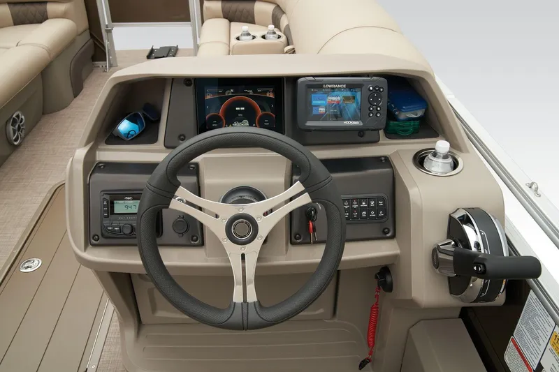 Slide: The Image of 2023 Sun Tracker SportFish 22 XP3 helm with steering wheel, controls, and navigation display. - 9