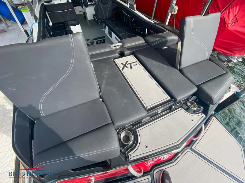 Slide: The Image of 2020 MasterCraft XT25 boat interior with black seating and stylish design. - 15