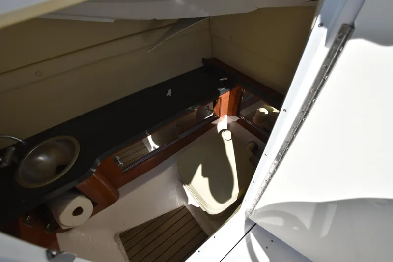 Slide: The Image of 2012 Regal 24 FasDeck boat interior with sink and toilet. - 11