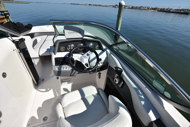 Slide: The Image of Cockpit of 2012 Regal 24 FasDeck boat with steering wheel and dashboard controls. - 12