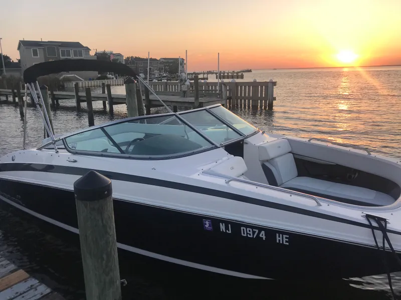 Slide: The Image of 2012 Regal 24 FasDeck boat docked at sunset, serene waterfront view. - 14