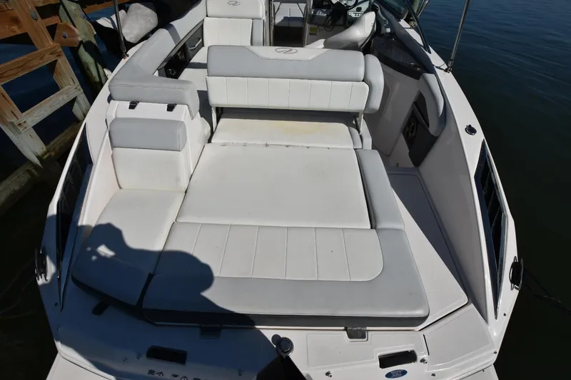 Slide: The Image of 2012 Regal 24 FasDeck boat with spacious white seating and sun deck. - 5