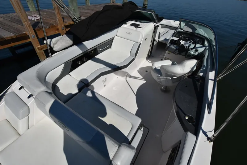 Slide: The Image of 2012 Regal 24 FasDeck boat interior with white seating and steering console. - 7