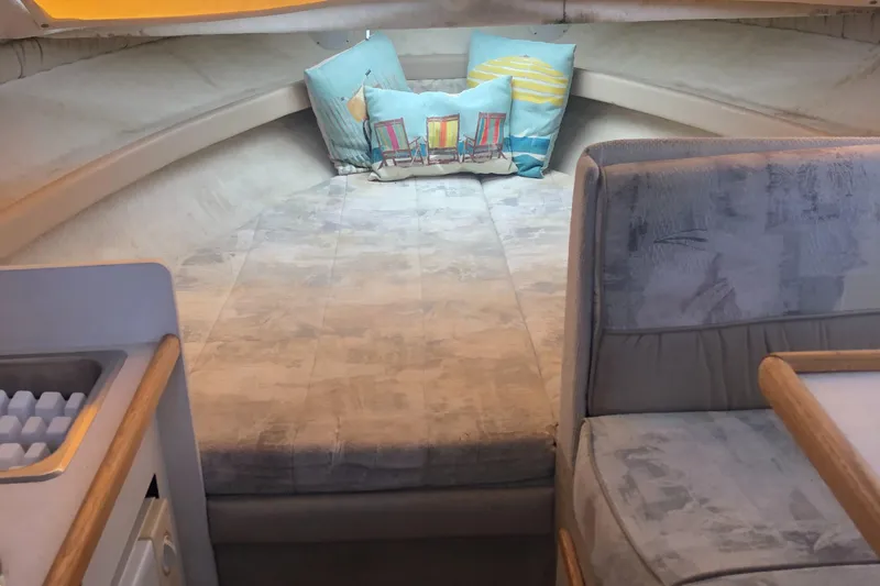 Slide: The Image of 1998 Bayliner 2452 Ciera Express cabin interior with bed and seating area. - 11