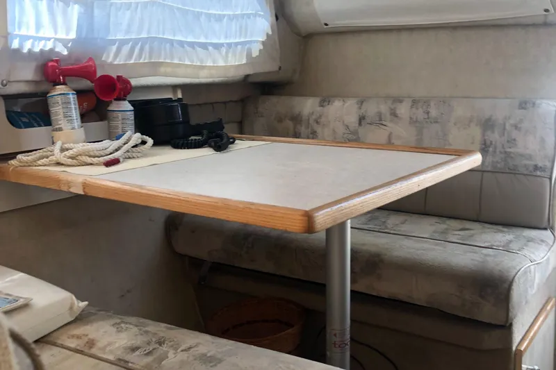 Slide: The Image of 1998 Bayliner 2452 Ciera Express cabin interior with dining table and seating. - 12