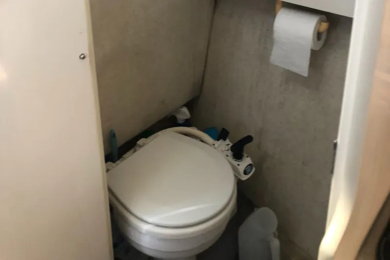 Slide: The Image of 1998 Bayliner 2452 Ciera Express boat bathroom with toilet and toilet paper holder. - 13