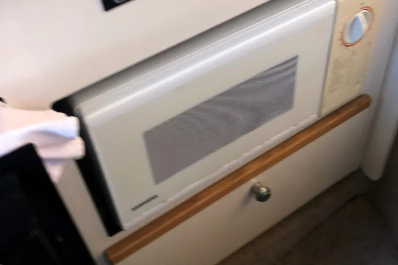Slide: The Image of Built-in microwave in the 1998 Bayliner 2452 Ciera Express boat kitchen. - 15