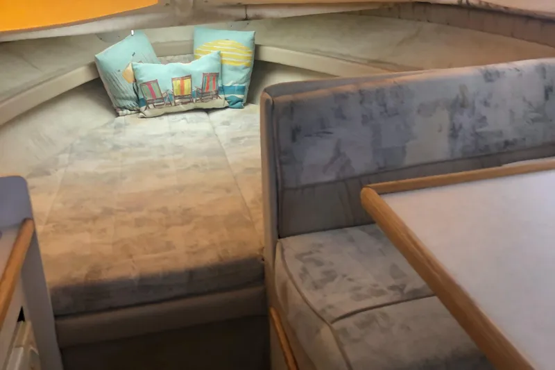 Slide: The Image of 1998 Bayliner 2452 Ciera Express cabin interior with bed and seating area. - 17
