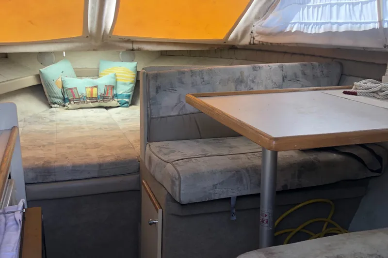 Slide: The Image of 1998 Bayliner 2452 Ciera Express cabin interior with seating and table. - 19