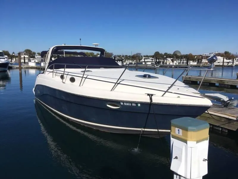 The Image of 2003 Rinker 342 Fiesta Vee boat docked in a marina. - 0