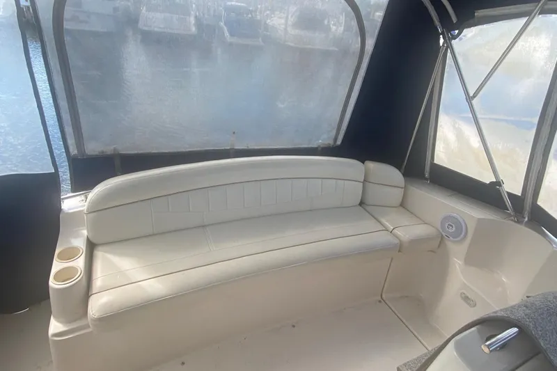 Slide: The Image of 2003 Rinker 342 Fiesta Vee boat interior with white seating and cup holders. - 2