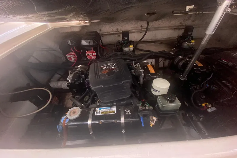 Slide: The Image of 2003 Rinker 342 Fiesta Vee engine compartment with visible components and wiring. - 3