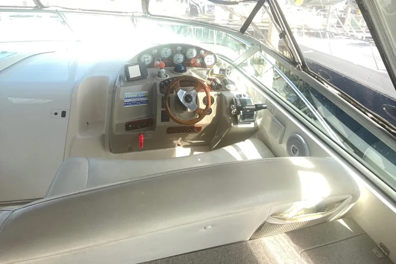 Slide: The Image of 2003 Rinker 342 Fiesta Vee boat cockpit with steering wheel and control panel. - 4
