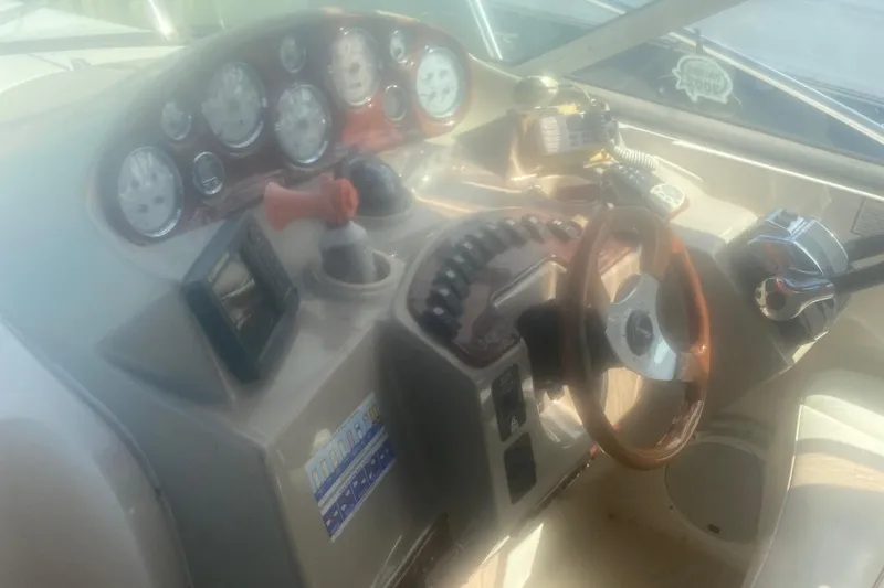 Slide: The Image of 2003 Rinker 342 Fiesta Vee boat dashboard with steering wheel and control panel. - 5