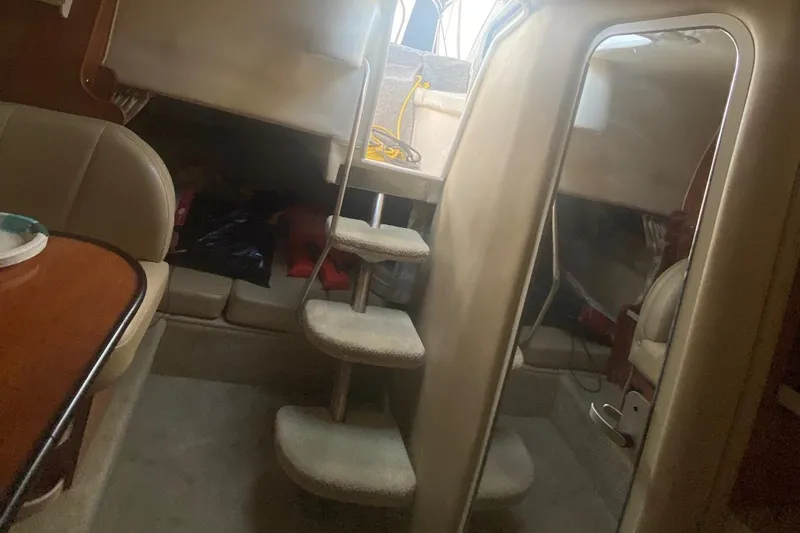 Slide: The Image of Interior cabin of a 2003 Rinker 342 Fiesta Vee boat with stairs and seating area. - 6