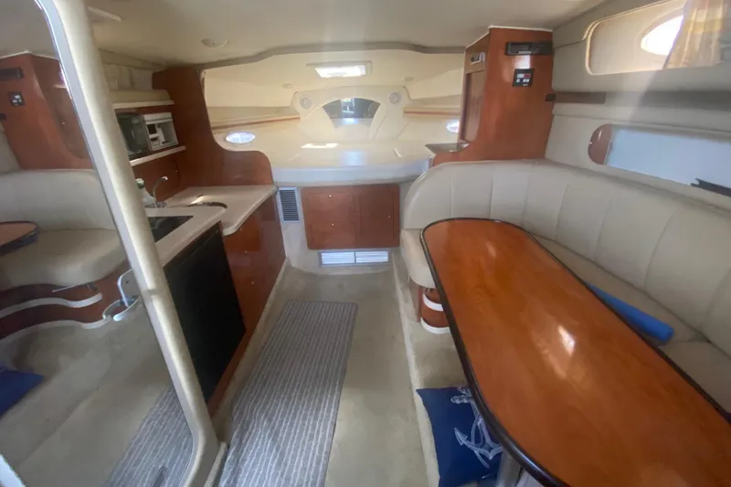 Slide: The Image of Interior of a 2003 Rinker 342 Fiesta Vee boat with kitchen and dining area. - 8
