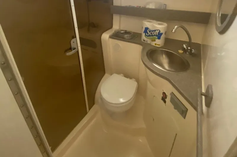 Slide: The Image of 2003 Rinker 342 Fiesta Vee boat bathroom with toilet, sink, and shower. - 9