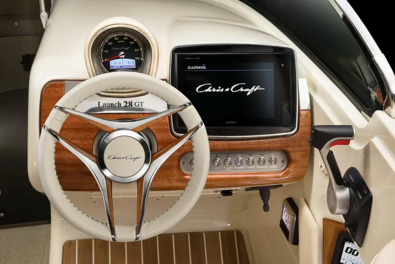 Slide: The Image of 2026 Chris-Craft Launch 28 GT dashboard with steering wheel and Garmin display. - 16