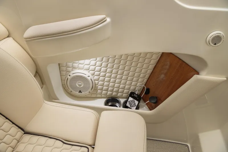 Slide: The Image of 2026 Chris-Craft Launch 28 GT interior with beige seating, speaker, and wood accents. - 18