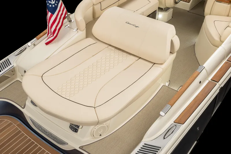 Slide: The Image of 2026 Chris-Craft Launch 28 GT boat interior with beige seating and American flag. - 19