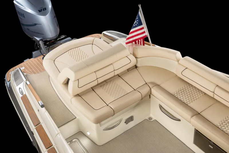 Slide: The Image of 2026 Chris-Craft Launch 28 GT boat interior with beige seating and American flag. - 22