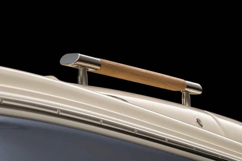 Slide: The Image of 2026 Chris-Craft Launch 28 GT boat detail with sleek wooden and metal handle. - 26