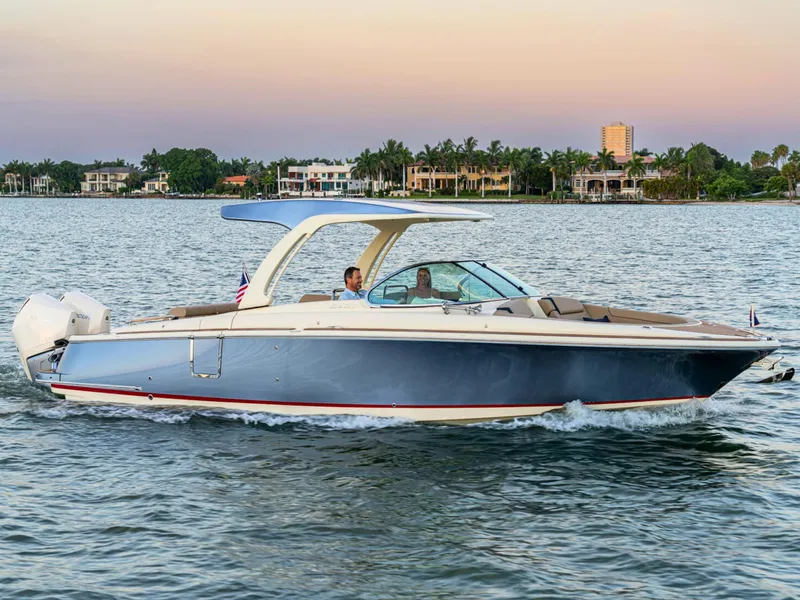 Slide: The Image of 2026 Chris-Craft Launch 31 GT cruising on a serene waterway at sunset. - 0