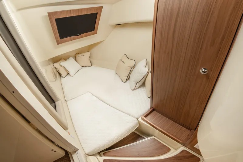 Slide: The Image of Luxurious cabin interior of 2026 Chris-Craft Launch 35 GT with cozy bedding and wooden accents. - 13