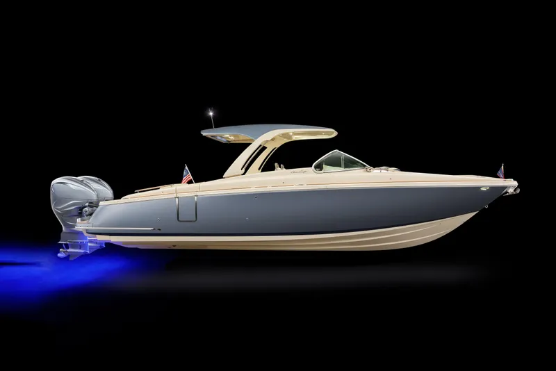 Slide: The Image of 2026 Chris-Craft Launch 35 GT boat with sleek design and blue hull, illuminated against black background. - 16