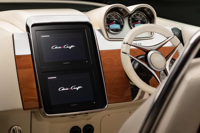 Slide: The Image of 2026 Chris-Craft Launch 35 GT dashboard with dual Garmin displays and elegant steering wheel. - 6
