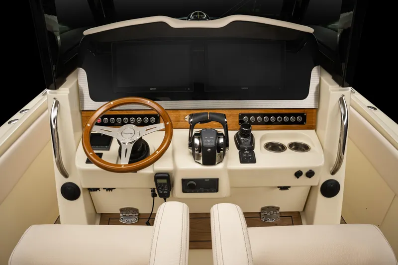 Slide: The Image of 2025 Chris-Craft Catalina 30 helm with modern controls and wooden steering wheel. - 10