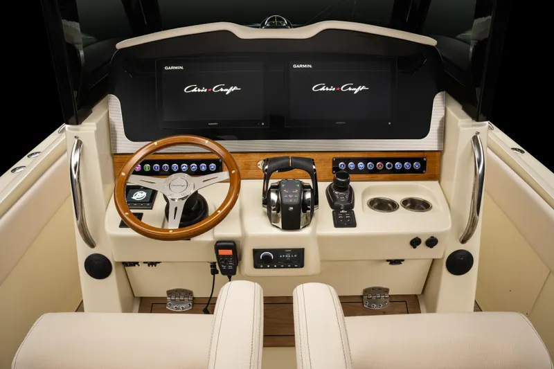 Slide: The Image of 2025 Chris-Craft Catalina 30 helm with modern controls and dual Garmin displays. - 11