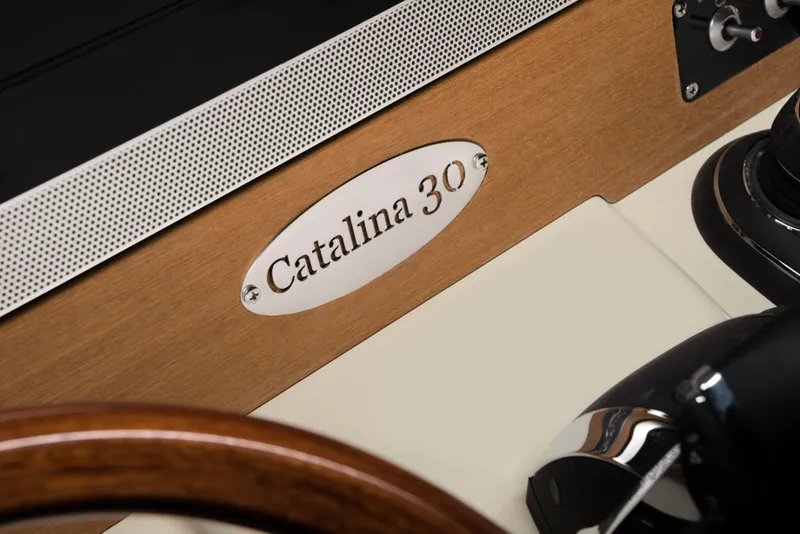 Slide: The Image of 2025 Chris-Craft Catalina 30 dashboard with elegant wood and metal detailing. - 12