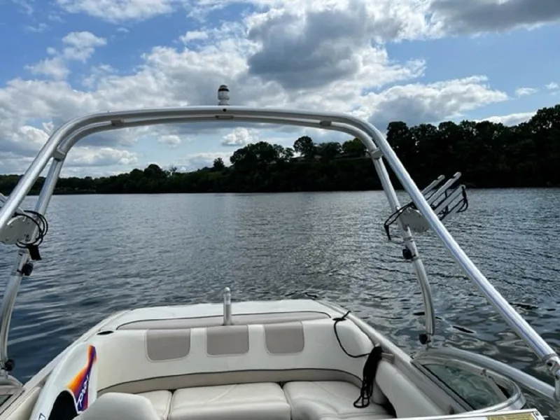 Slide: The Image of 1999 MasterCraft MariStar 210 on a calm lake under cloudy skies. - 10