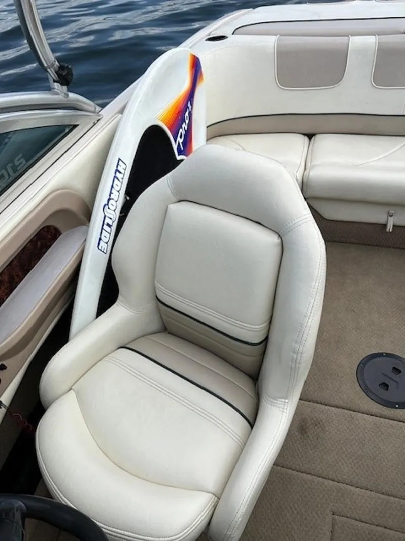 Slide: The Image of Interior of a 1999 MasterCraft MariStar 210 boat with beige seating. - 11