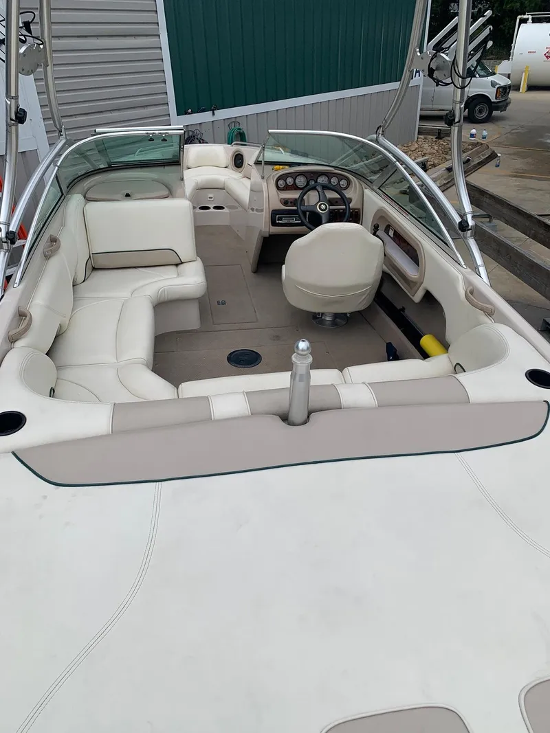 Slide: The Image of Interior view of a 1999 MasterCraft MariStar 210 boat with beige seating. - 13