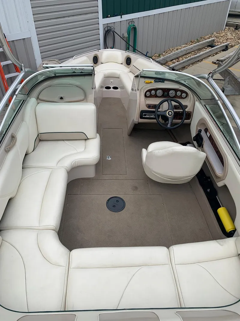 Slide: The Image of Interior of a 1999 MasterCraft MariStar 210 boat with beige seating. - 14