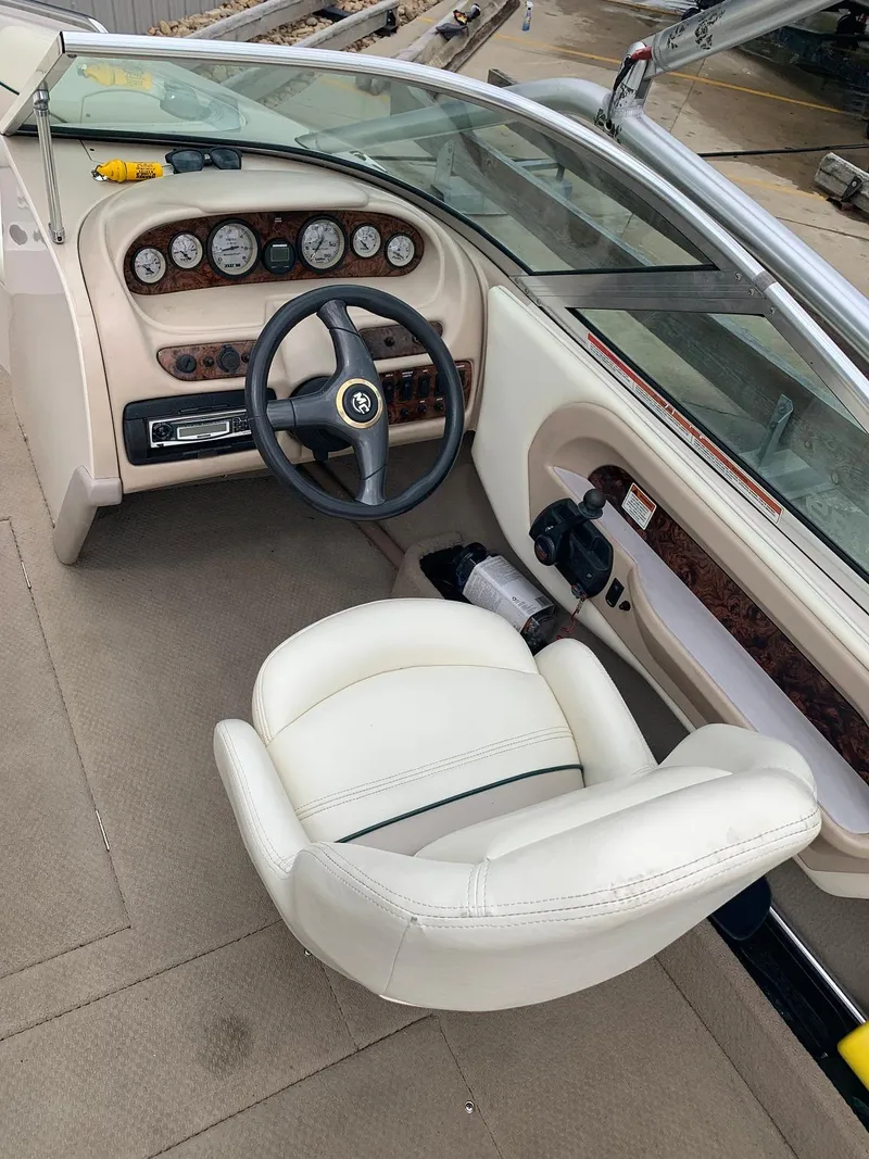 Slide: The Image of Interior of a 1999 MasterCraft MariStar 210 boat with steering console. - 17