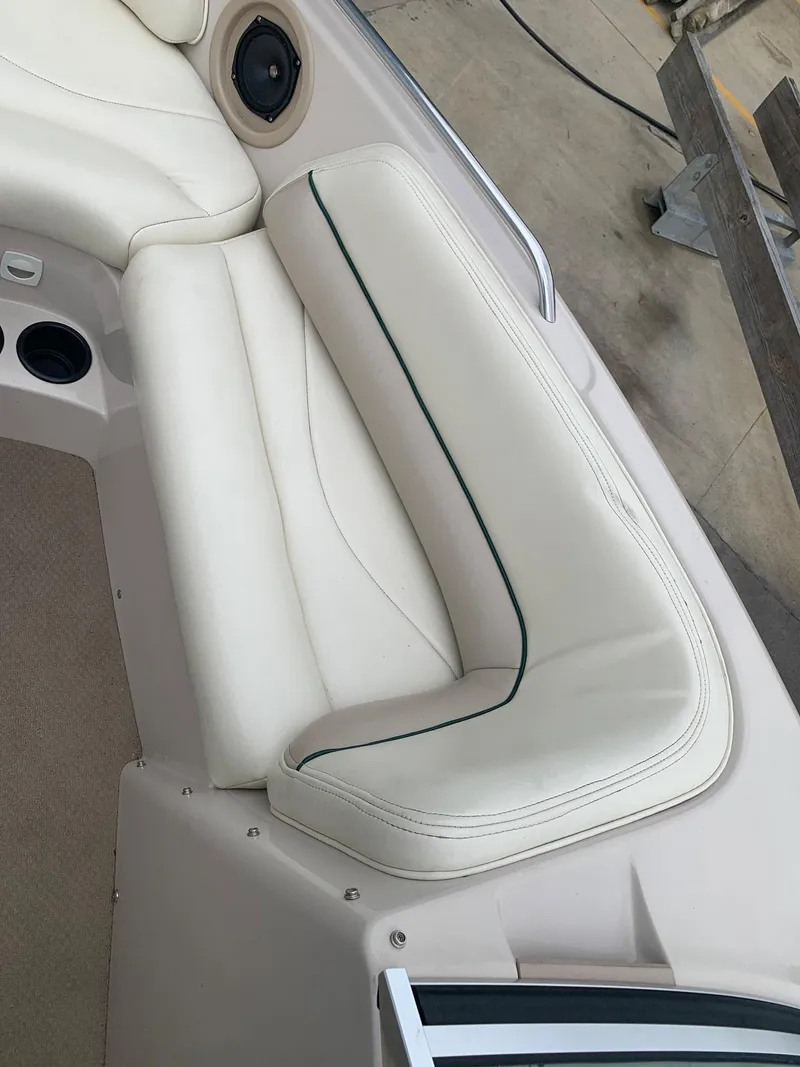 Slide: The Image of Interior of a 1999 MasterCraft MariStar 210 boat with white upholstery. - 23