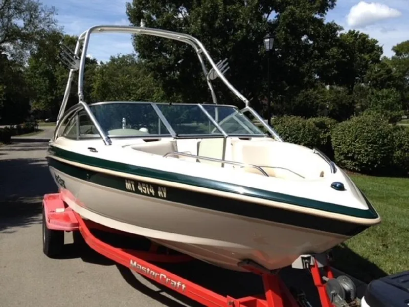Slide: The Image of 1999 MasterCraft MariStar 210 boat on red trailer outdoors. - 3