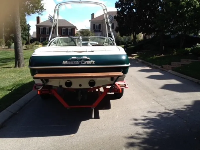Slide: The Image of 1999 MasterCraft MariStar 210 boat on trailer in residential street. - 4