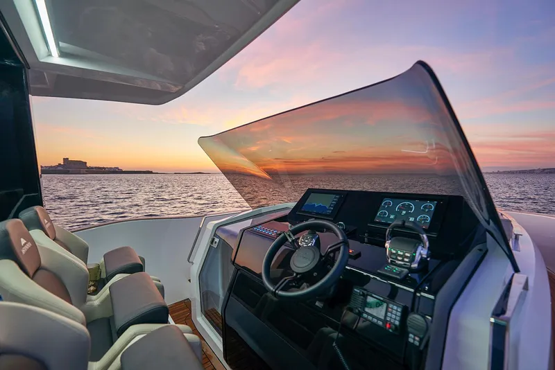 Slide: The Image of 2023 Astondoa 377 Coupe helm with sunset view over the ocean. - 13