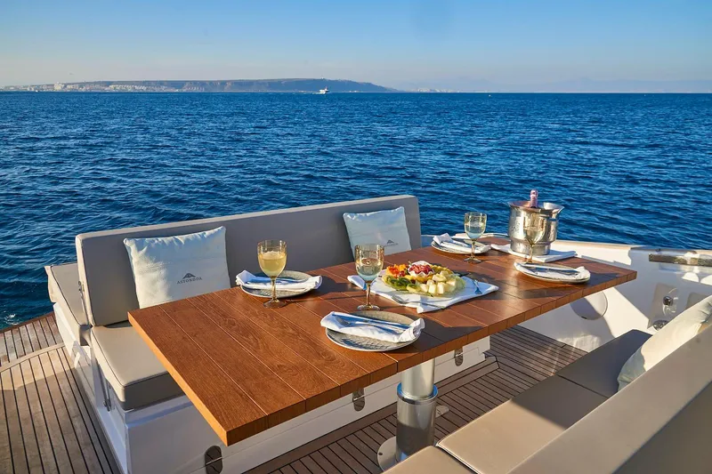 Slide: The Image of Luxury dining setup on the 2023 Astondoa 377 Coupe yacht with ocean view. - 16