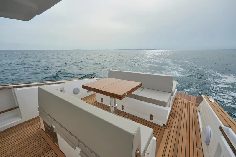 Slide: The Image of Astondoa 377 Coupe 2023 yacht deck with ocean view and seating area. - 19