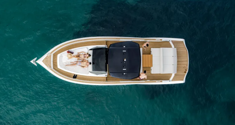 Slide: The Image of Aerial view of 2023 Astondoa 377 Coupe yacht on clear blue water. - 7