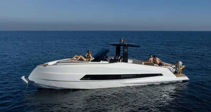 Slide: The Image of 2023 Astondoa 377 Coupe yacht cruising on open water with passengers relaxing. - 9
