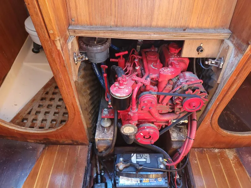 Slide: The Image of 1984 Elite 32 boat engine compartment with red engine and battery - 2