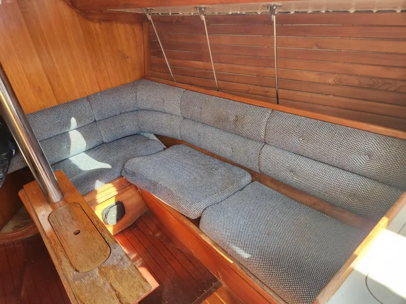Slide: The Image of Interior of 1984 Elite 32 sailboat with wooden paneling and cushioned seating. - 6